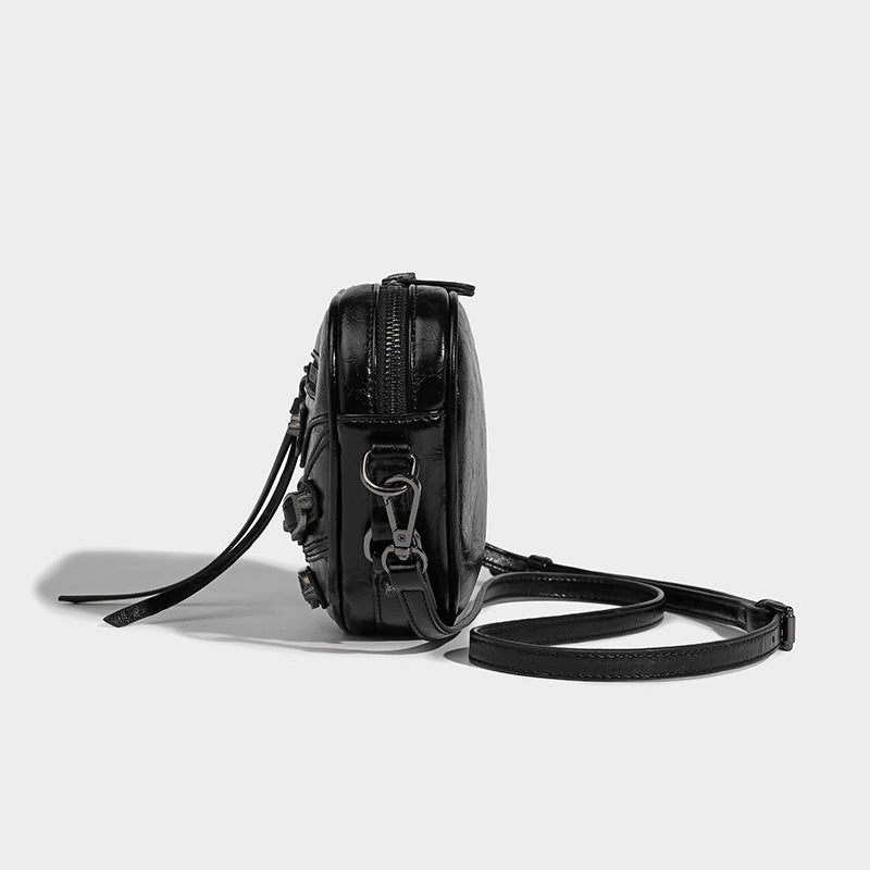 Mini heart-shaped crossbody bag with glossy crinkled finish and moto buckle hardware, detail view 21