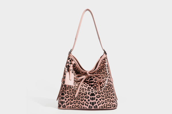 Slouchy leopard print shoulder hobo bag with black leather-look trim, tie-top closure, and single long strap, detail view 22