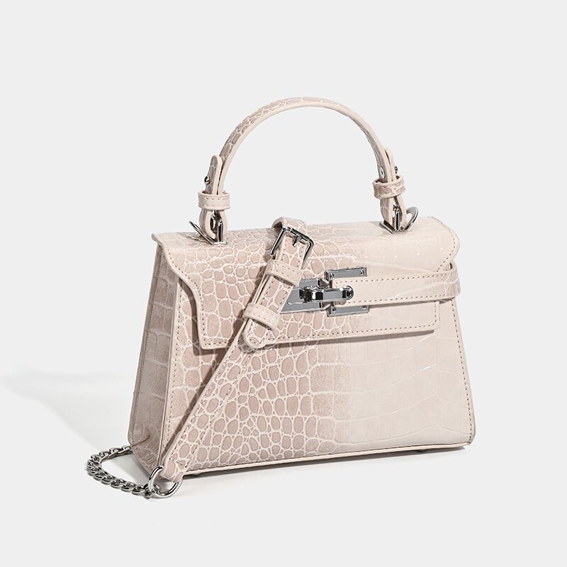 Croc-embossed mini top-handle satchel with silver turn-lock closure and adjustable crossbody strap, detail view 3