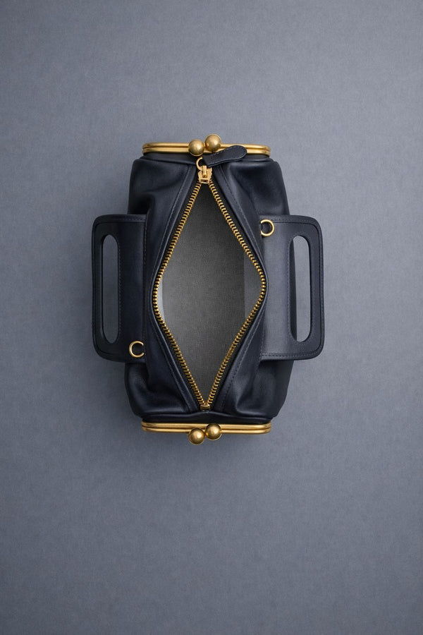 Kompakte dunkelbraune Henkeltasche in Lederoptik mit goldfarbenem Rahmenbeschlag und abnehmbarem, verstellbarem Crossbody-Riemen