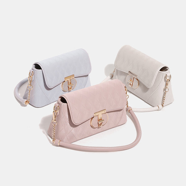 Small structured diamond-quilted flap bag with gold-tone turn-lock closure, chain shoulder strap, and cylindrical top handle