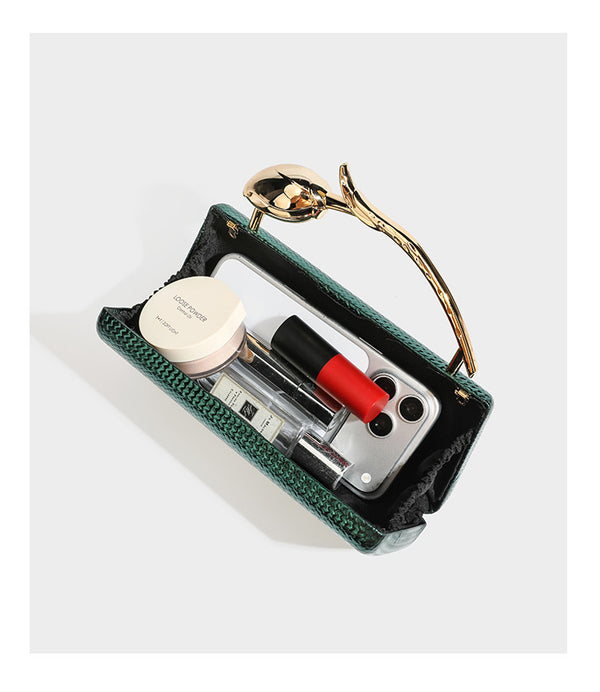 Structured rectangular metallic woven clutch bag with sculptural gold-tone leaf top handle and detachable chain strap, detail