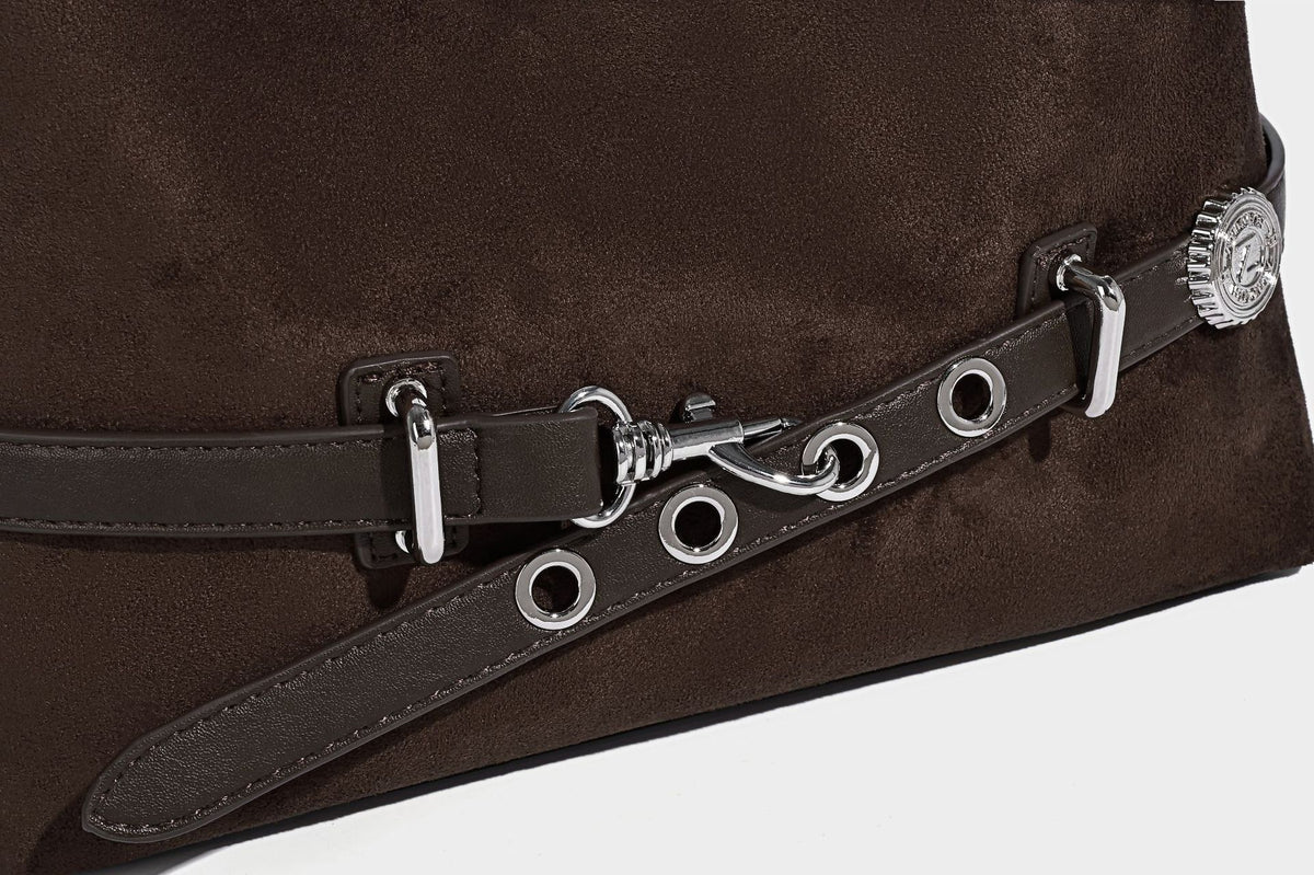 Hobo-Schultertasche in Dunkelbraun mit velourslederartiger Oberfläche, silberfarbener Gürtelschnalle und Ösenbeschlägen, verstellbarem Riemen, Detailansicht