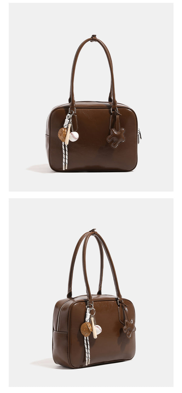 Strukturierte Satchel-Tasche mit abgerundeter rechteckiger Form und Tragegriff, glänzender Lederimitat-Oberfläche, silberfarbenen Beschlägen und, Detailansicht