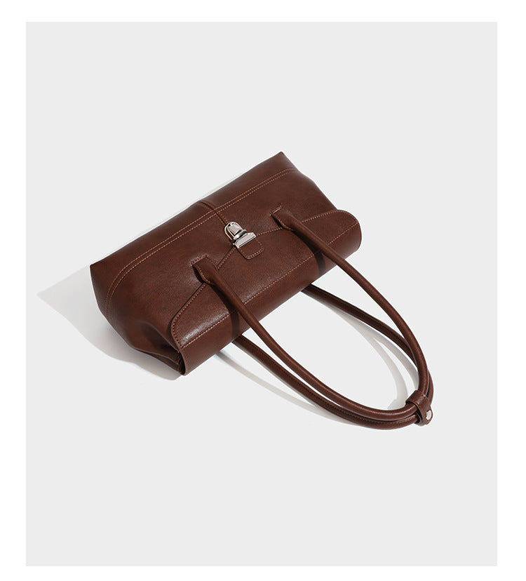 Structured rectangular satchel bag with dual rounded top handles and central metal turn-lock flap closure, detail view 11