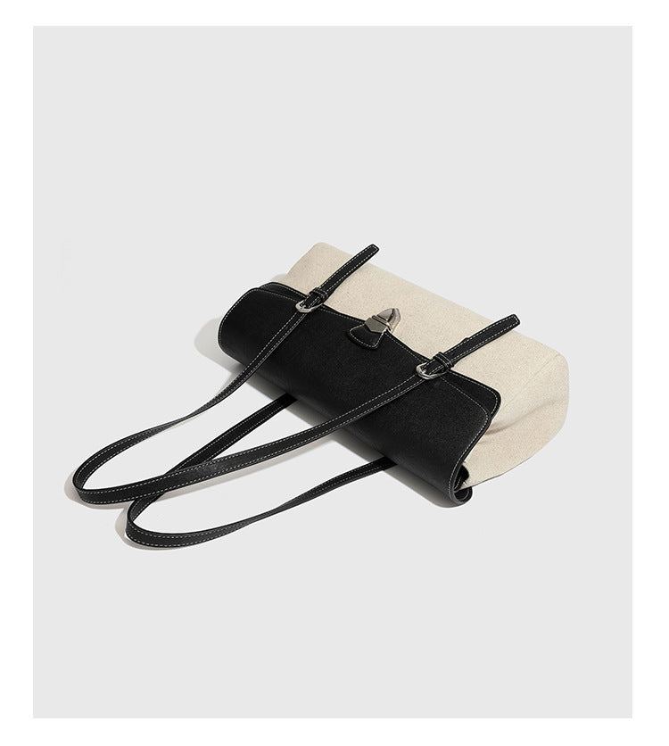 Strukturierte zweifarbige Schultertasche mit schwarzer Klappe in Lederoptik, cremefarbenem Korpus mit Webstruktur, silberfarbenem Drehverschluss und doppeltem