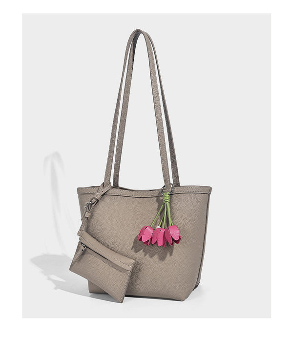 Structured pebbled leather-look tote bag in taupe with long shoulder strap, detachable zip pouch, and pink tulip flower