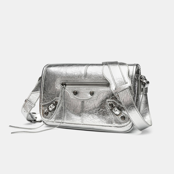 Small structured rectangular crossbody bag with crinkle leather-look finish, front zip pocket, gunmetal stud hardware, and