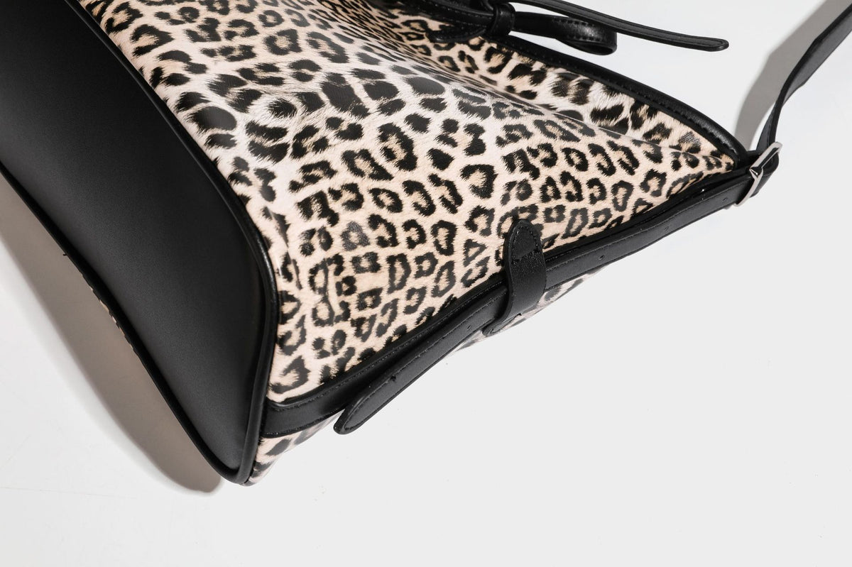 Slouchy leopard print shoulder hobo bag with black leather-look trim, tie-top closure, and single long strap, detail view 37
