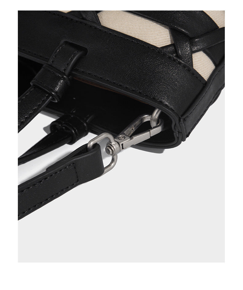 Structured woven lattice tote bag with cream lining, dual top handles, detachable crossbody strap, and silver-tone hardware