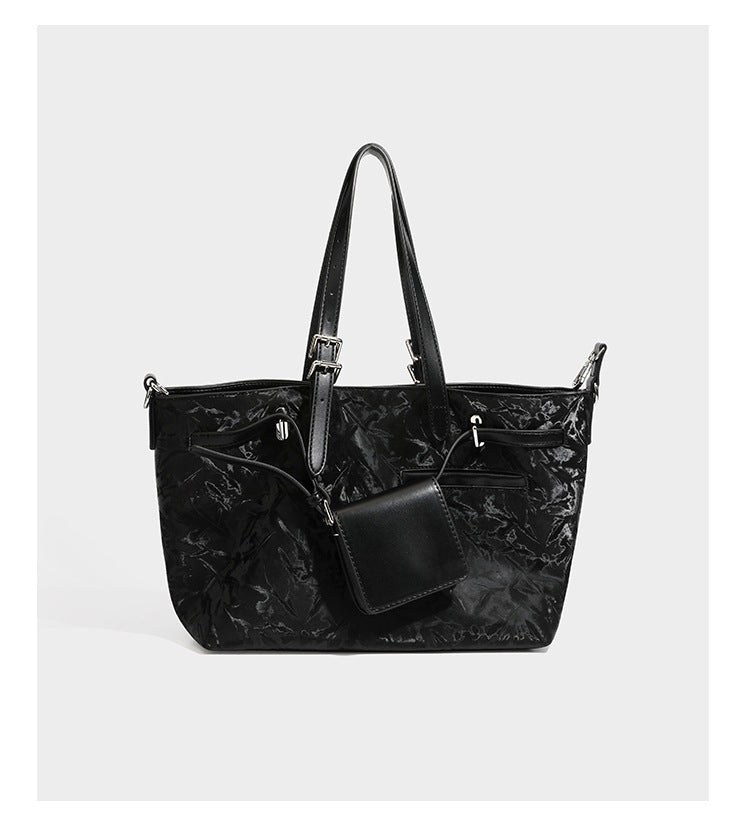Glossy crinkled metallic-finish tote bag in brown with smooth leather-look top handles, silver-tone hardware, and attached