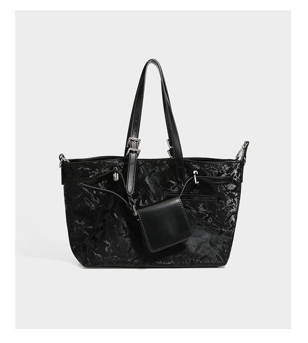 Glossy crinkled metallic-finish tote bag in brown with smooth leather-look top handles, silver-tone hardware, and attached