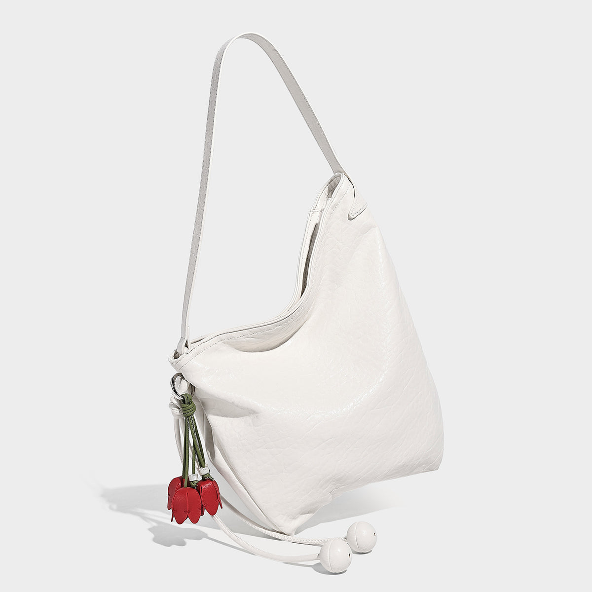 Lässige Hobo-Schultertasche in Hellgelb mit schmalem Riemen, Perlenverschluss mit Kordelzug und rosafarbenem Tulpenblumen-Anhänger, Vorderansicht