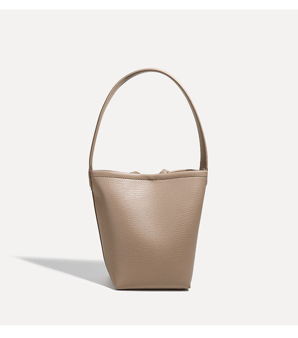 Mini tapered bucket bag in pebbled leather-look finish with front tie straps and single shoulder strap, detail view 14