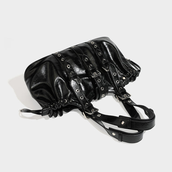 Large black glossy leather-look tote bag with silver buckle straps, eyelet grommet panels, drawstring side gathers, and
