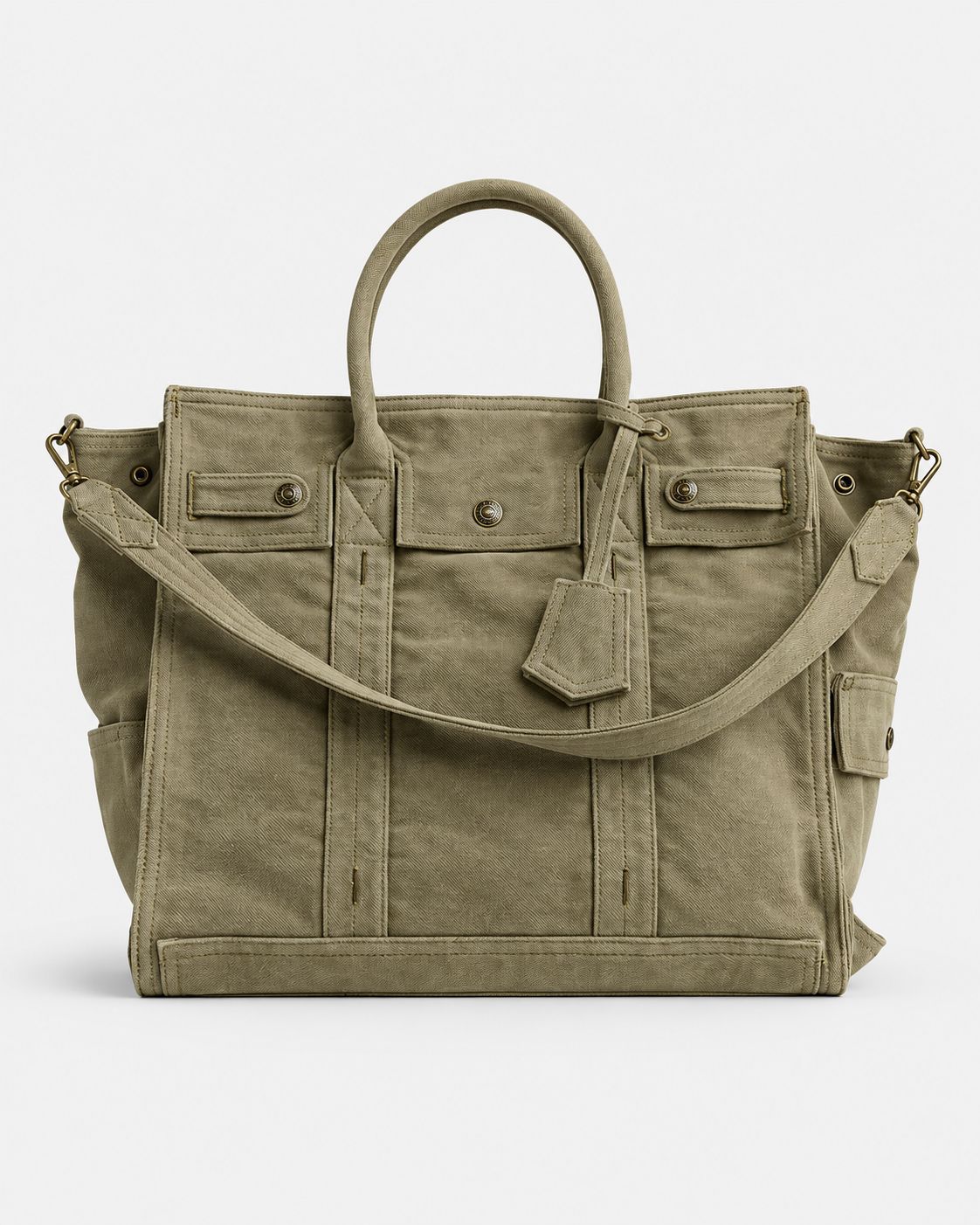 Large washed denim patchwork tote bag with snap-flap front pockets, rolled handles, and detachable shoulder strap, detail