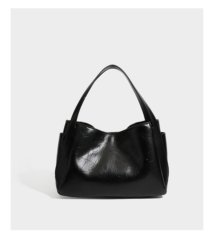 Black glossy crinkled leather-look convertible shoulder tote bag with gold gourd-shaped emblem hardware and detachable