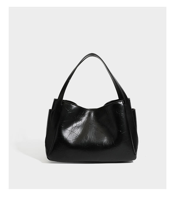 Black glossy crinkled leather-look convertible shoulder tote bag with gold gourd-shaped emblem hardware and detachable