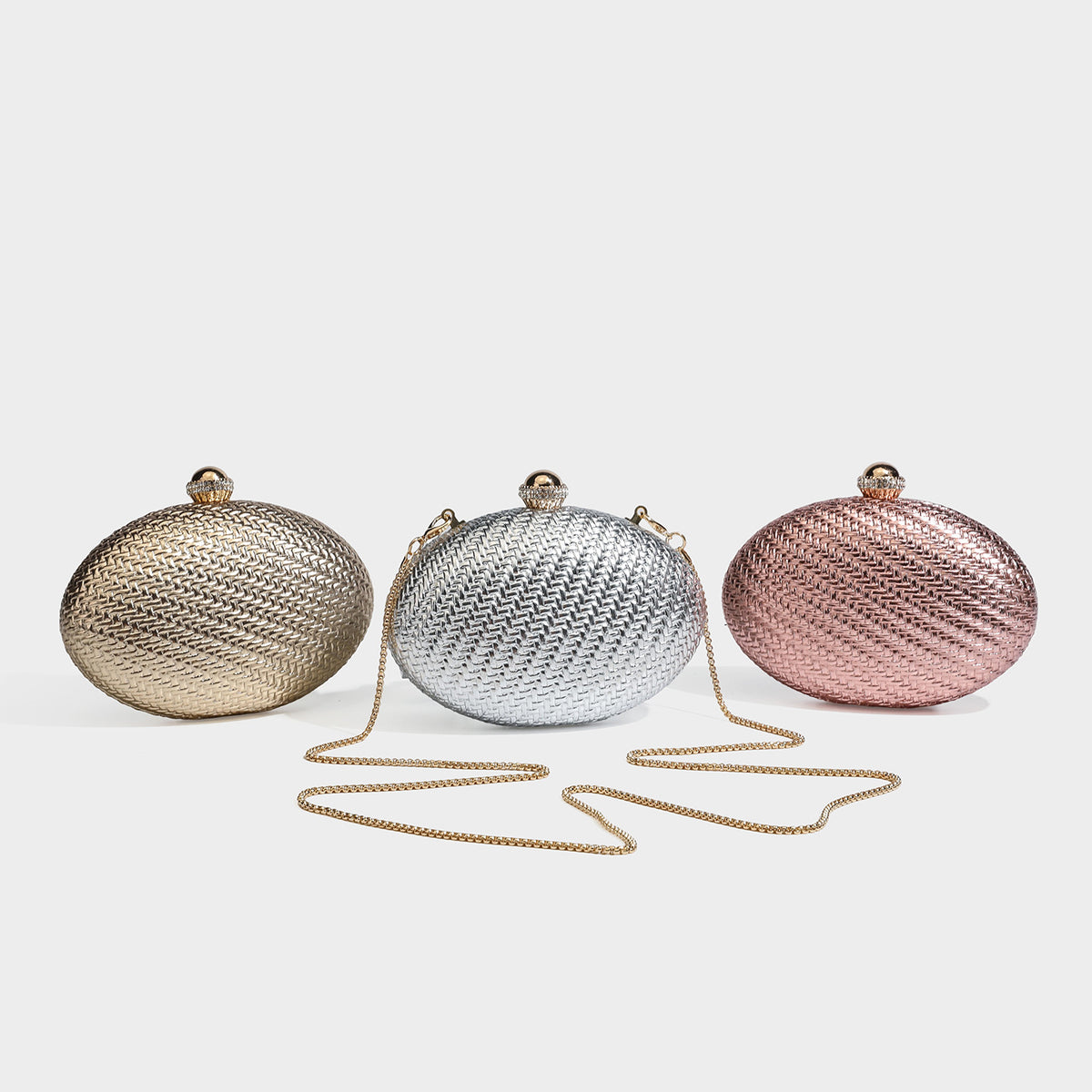 Small oval metallic woven clutch bag with jeweled gold-tone kiss-lock clasp and detachable chain strap, detail view 2