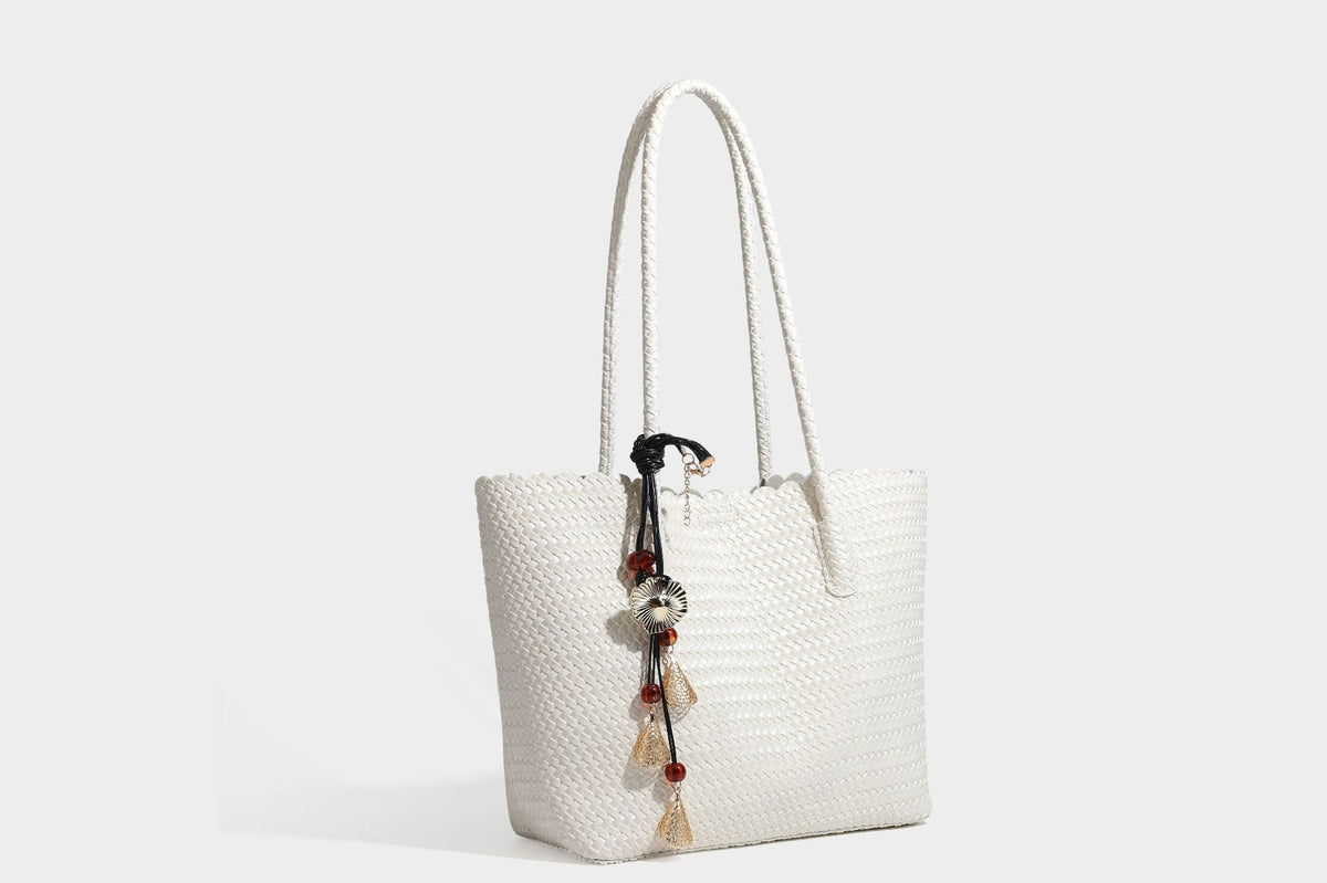 Large open-top woven leather-look tote bag in dark brown with scalloped edge, braided double shoulder straps, and decorative