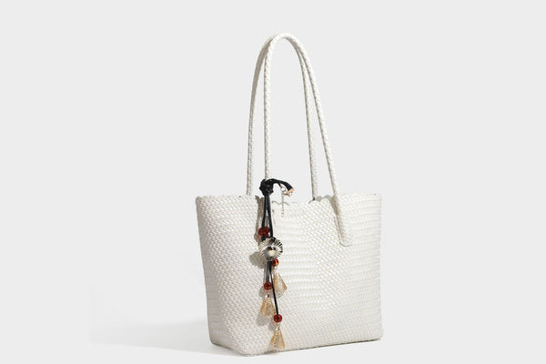 Large open-top woven leather-look tote bag in dark brown with scalloped edge, braided double shoulder straps, and decorative
