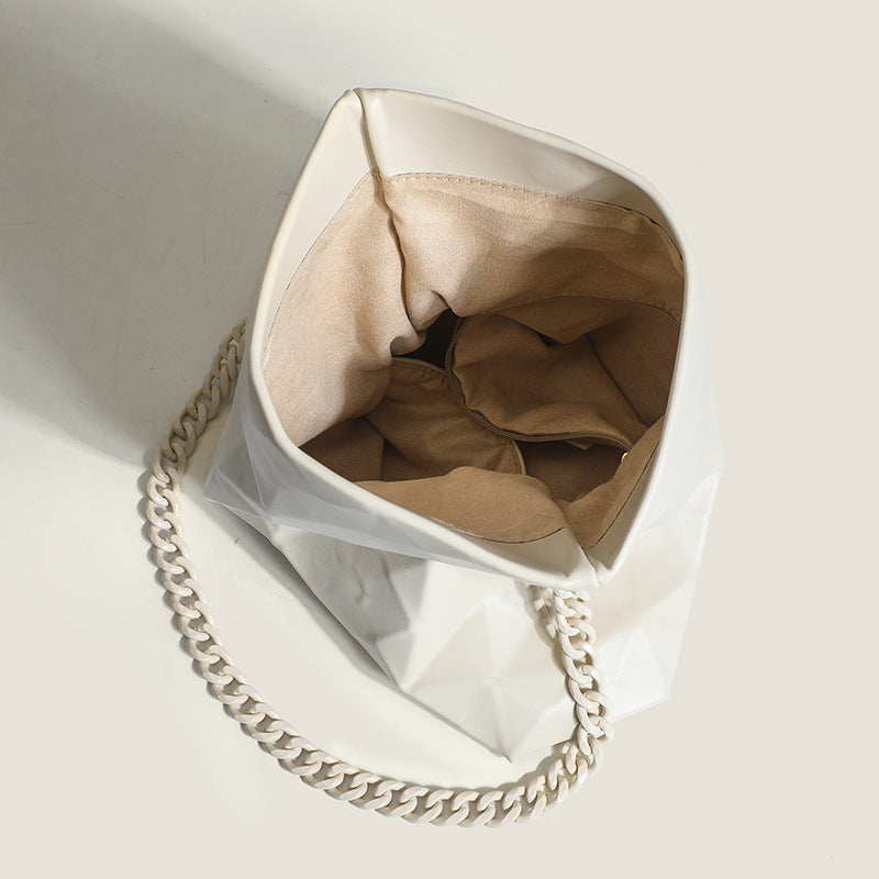 Cream white rectangular flap shoulder bag with geometric faceted surface and chunky tone-on-tone chain strap with gold-tone