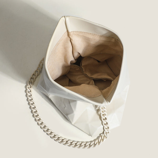 Cream white rectangular flap shoulder bag with geometric faceted surface and chunky tone-on-tone chain strap with gold-tone