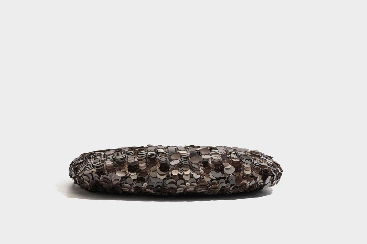 Small sequin half-moon handbag with circular wood-look ring handles and detachable leather-look shoulder strap, detail view