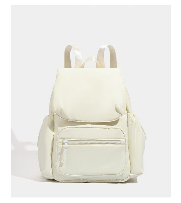 Soft matte nylon flap backpack with front zip pocket and side drawcord pockets, detail view 9