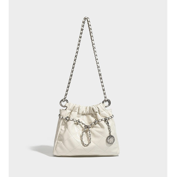 Glossy diamond-quilted drawstring bucket bag with silver chain shoulder strap and medallion charm, detail view 4