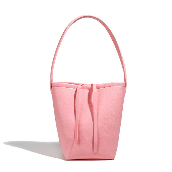 Mini tapered bucket bag in pebbled leather-look finish with front tie straps and single shoulder strap, detail view 5