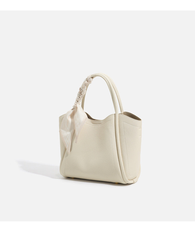 Pebbled leather-look bucket tote bag with scarf-wrapped top handle and gold-tone hardware, detail view 18