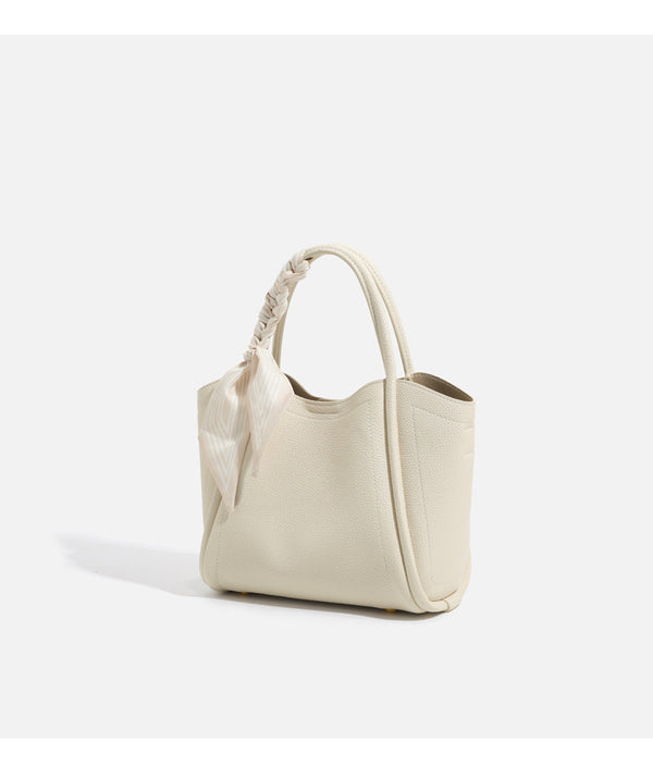 Pebbled leather-look bucket tote bag with scarf-wrapped top handle and gold-tone hardware, detail view 18