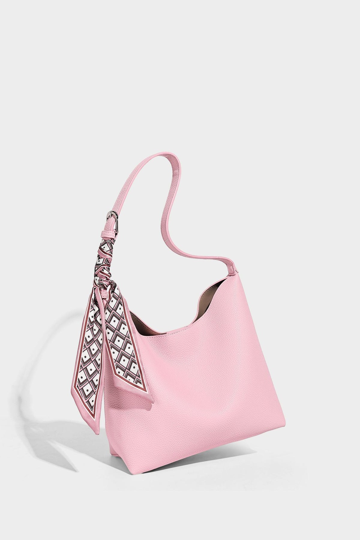 Soft slouchy hobo shoulder bag in pebbled matte finish with slim strap, silver-tone ring hardware, and knotted printed scarf