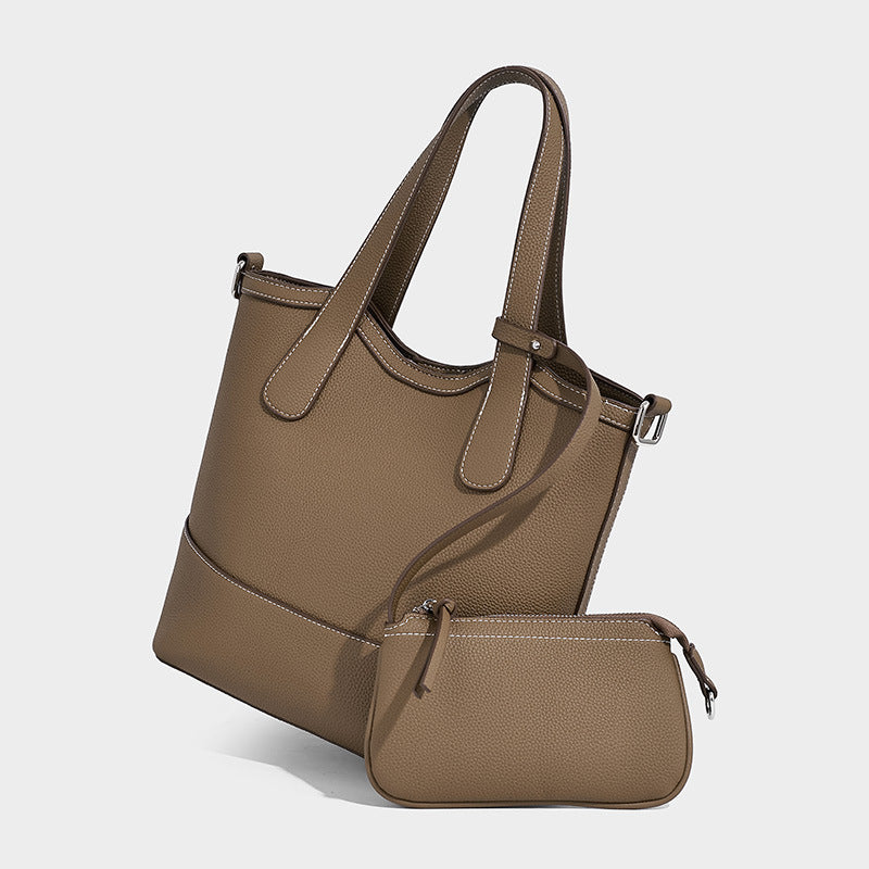 Structured pebbled-finish tote bag in caramel brown with dual top handles, detachable crossbody strap, and removable zip