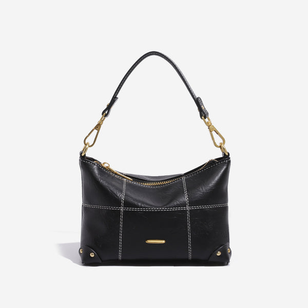 Small soft-structured shoulder bag with curved zip closure, stitched panel detailing, and gold-tone hardware, detail view 7