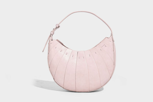 Crescent half-moon shoulder bag with vertical panel seaming, matte-satin leather-look finish, and adjustable gold-tone