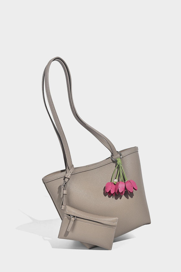 Structured pebbled leather-look tote bag in taupe with long shoulder strap, detachable zip pouch, and pink tulip flower