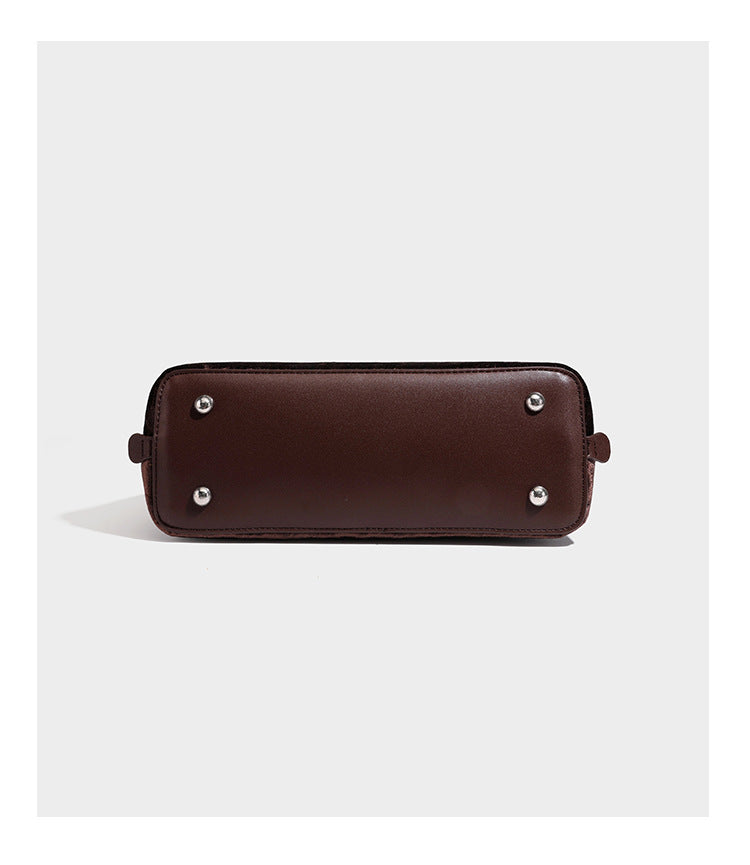 Small structured satchel bag in dark brown velvet-like textured finish with leather-look trim, silver-tone turn-lock bar