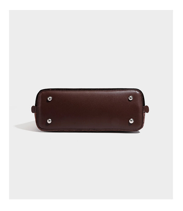 Small structured satchel bag in dark brown velvet-like textured finish with leather-look trim, silver-tone turn-lock bar