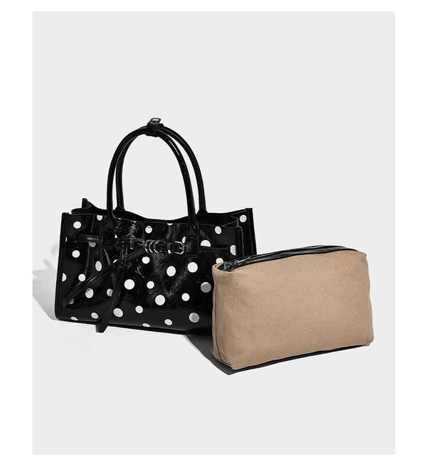 Structured glossy polka-dot tote bag with double top handles and front buckle hardware, detail view 8