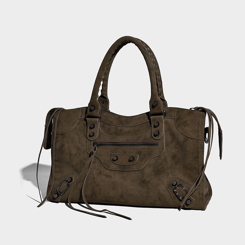 Structured matte suede-look satchel bag with braided top handles, dark stud hardware, front zip pocket, and detachable, front