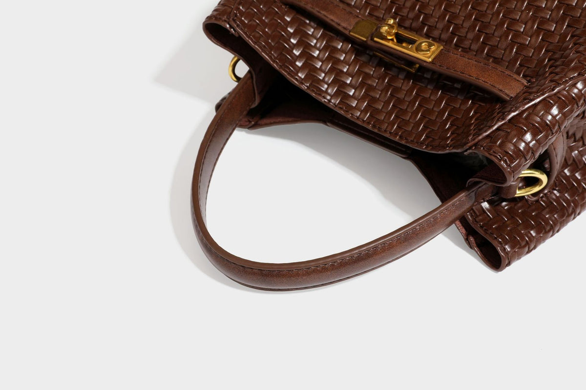 Structured woven leather-look bucket bag with gold-tone turn-lock hardware and detachable shoulder strap, detail view 38