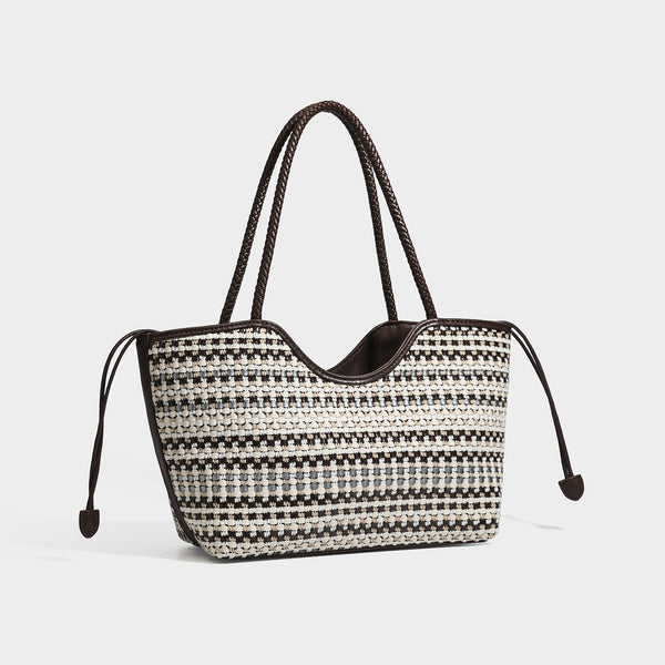 Large woven checker-pattern tote bag with dark braided shoulder straps, leather-look trim, and drawstring side ties, front