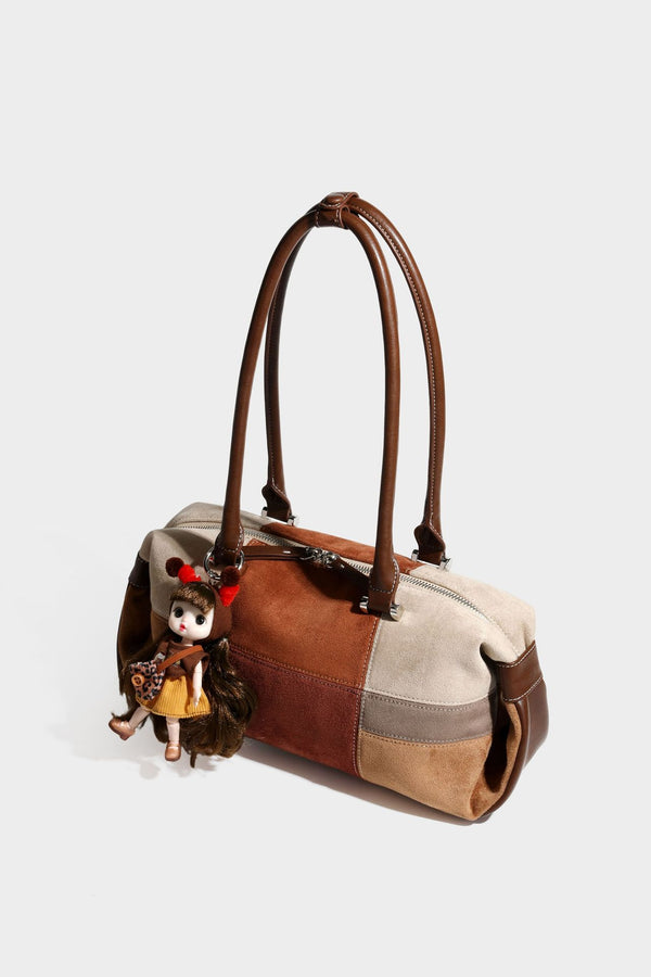 Patchwork suede-look barrel shoulder bag in brown, rust, tan, beige, and gray panels with double leather-look straps and