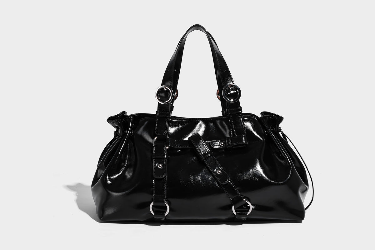 Glossy patent-look slouchy tote bag with ruched drawstring sides, dual top handles, silver ring hardware, and detachable