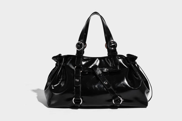 Glossy patent-look slouchy tote bag with ruched drawstring sides, dual top handles, silver ring hardware, and detachable