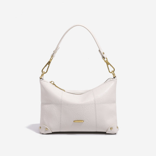 Small soft-structured shoulder bag with curved zip closure, stitched panel detailing, and gold-tone hardware, detail view 6
