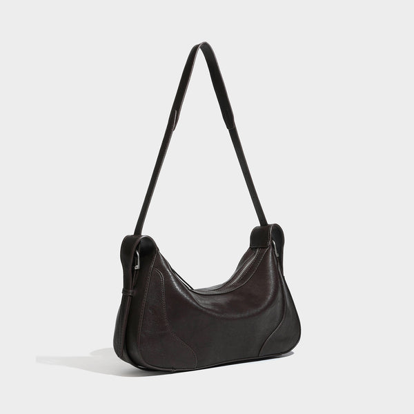 Slouchy crescent hobo shoulder bag in dark brown pebbled leather-look finish with zip top and long shoulder strap, detail