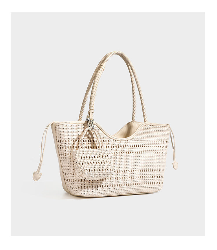 Strukturierte Henkeltasche aus geflochtenem Material in Dunkelbraun mit geflochtenen Henkeln, seitlichen Zugbändern und befestigtem Mini-Täschchen aus geflochtenem Material mit